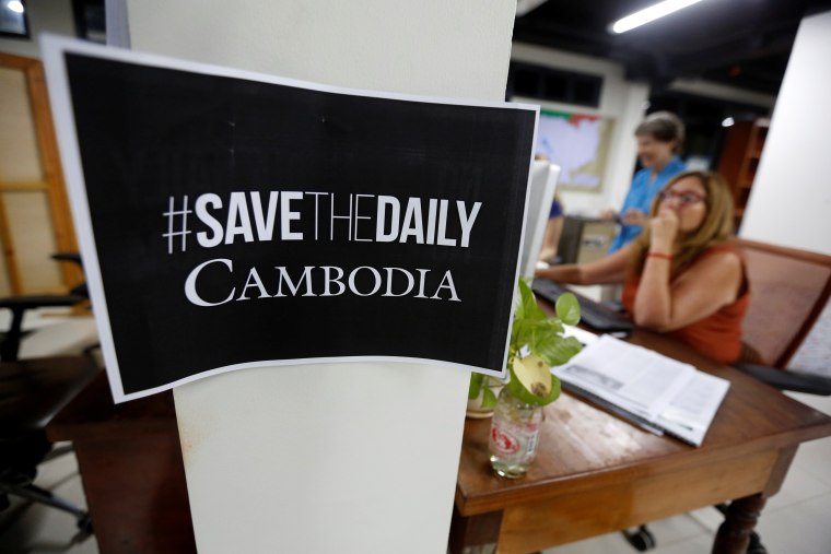 Image: Journalists work at the newsroom of The Cambodia Daily newspaper in Phnom Penh