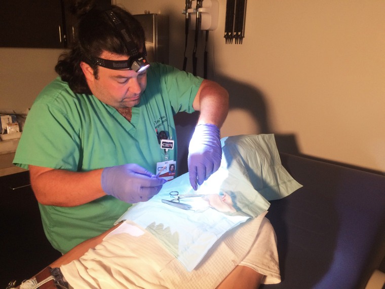 Image: Dr. Luke LeBas works on a patient at Code 3 ER and Urgent Care