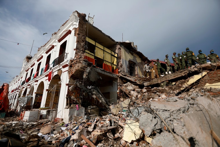 Image: Soldiers remove the debris of a house after an earthquake struck off the southern coast Mexico