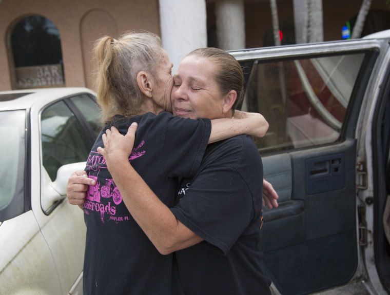 Image: Gator's Crossroads owner Linda Pauly, right, embraces cook Candy Canfield outside the bar before saying goodbye on Friday, Sept. 8, 2017 in Collier County, Florida.