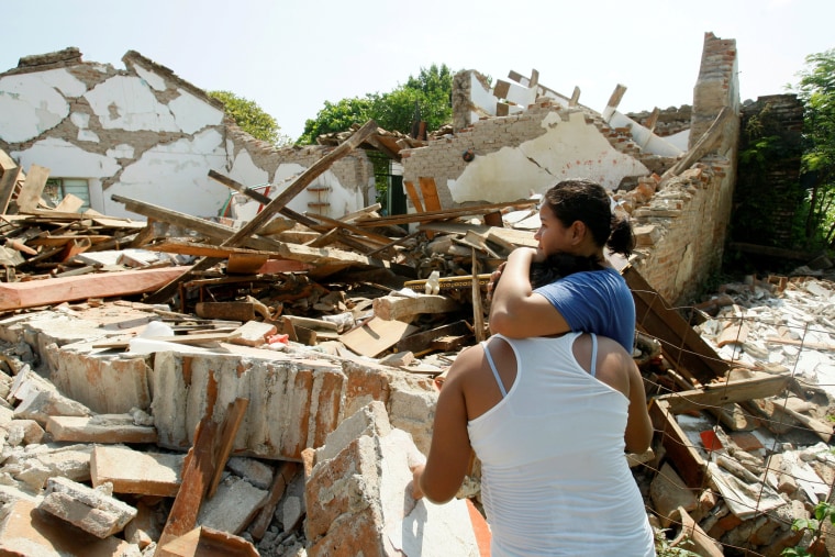 Image: Women hug while next to a destroyed house in Union Hidalgo, Mexico after the powerful earthquake.