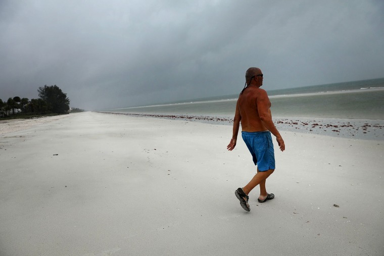 Image: Larry Mawer goes for a swim on a deserted beach in Bonita Springs as Hurricane Irma arrives into southwest Florida on Sept.10.