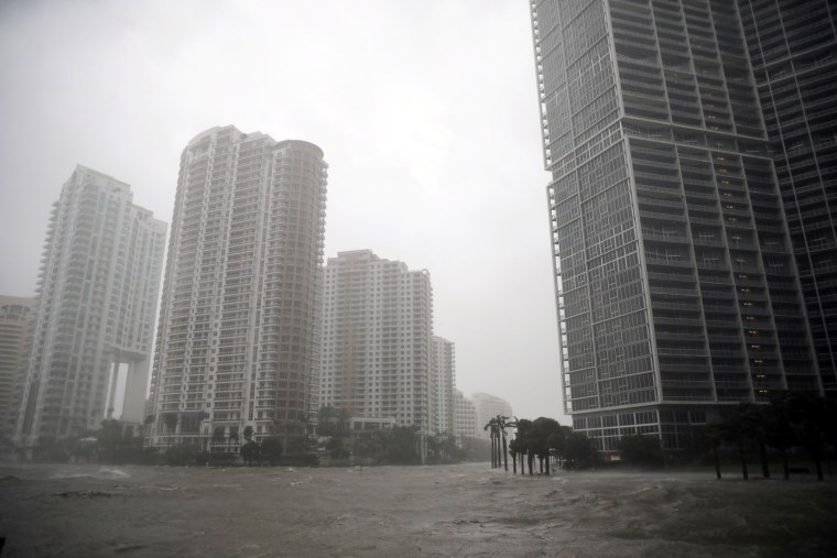 Image: Water rises up to a sidewalk by the Miami river in Downtown Miami on Sept. 10.