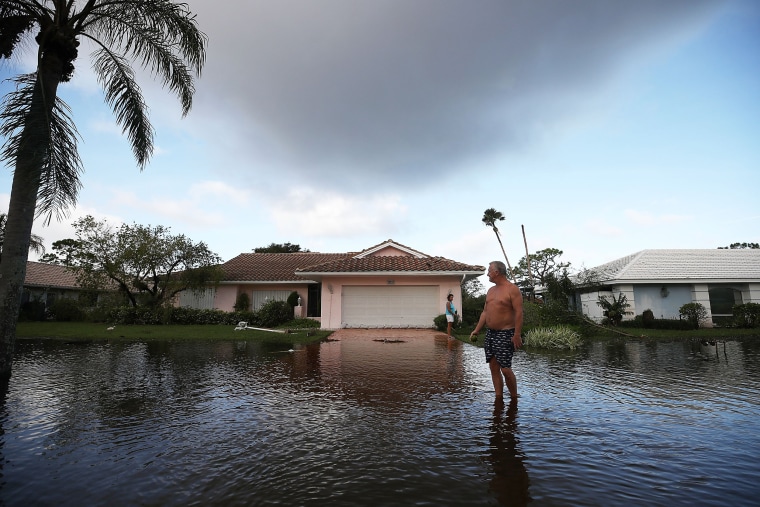 Image:  Jerry Darnell stands in front of his house that was flooded by Hurricane Irma
