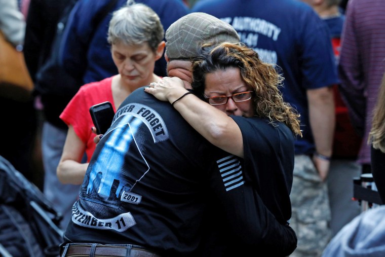 Image: People embrace as they gather at the National 911 Memorial and Museum during ceremonies marking the 16th anniversary of the September 11, 2001 attacks in New York