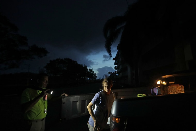 Image: Laura and Joe Raymond pack up their truck to leave the fourth floor apartment of Joe's mother, where they rode out the hurricane, to return to their low lying home a mile away in Marco Island on Sept. 11.