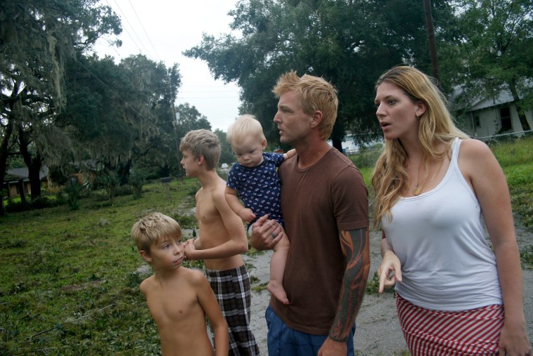 Image: Zachary Harrison, his fiance Cheyanne O'Donnell and their three children, Jaiden, 14, Jackson, 9, and Ella, 10-months, get their first look at the damage to their neighborhood caused by Hurricane Irma in Fort Meade on Sept. 11.