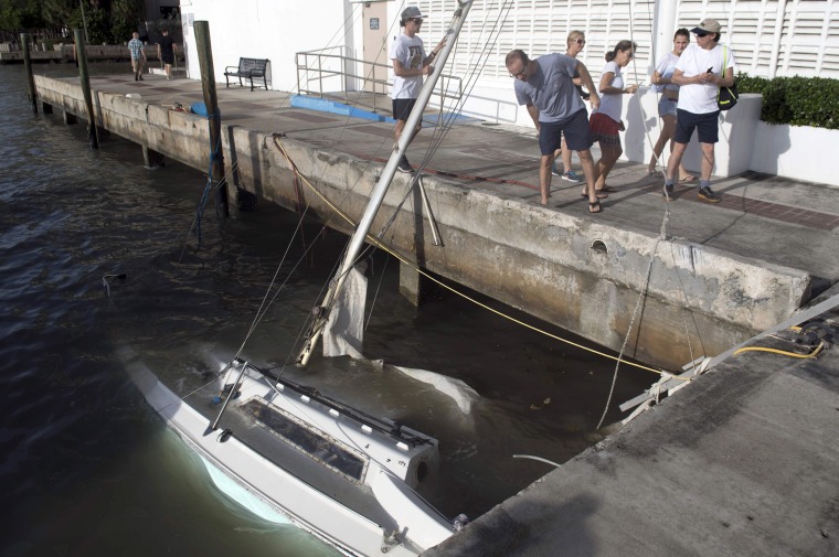 Image: Partially submerged boats sit in a marina in downtown Miami on Sept. 11.