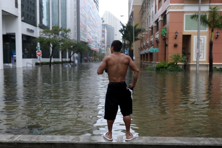 Image: Local resident Vishnu Obregon surveys the flooding in the Brickell neighborhood of Miami on Sept. 10, 2017.