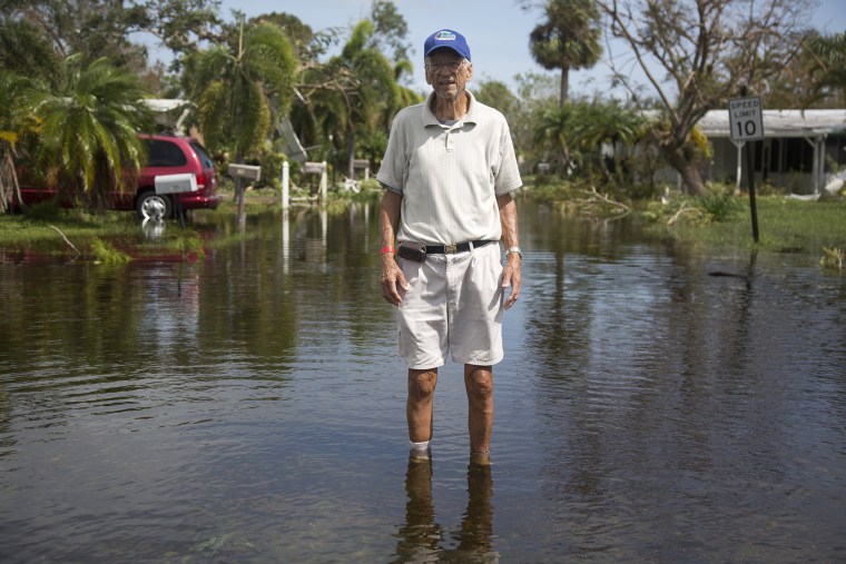 Image: Richard Nowak surveys the damage to his home in Holiday Manor in Naples