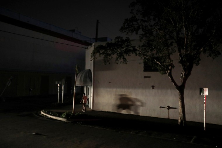 Image: A man walks in the darkness as many areas of Miami still without electricity after Hurricane Irma strikes Florida, in Little Havana, Miami, Florida,