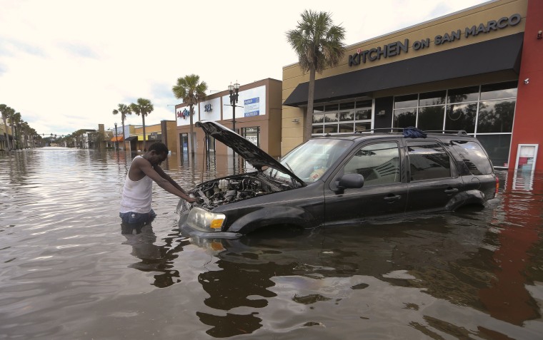 Image: John Duke tries to figure out how to salvage his flooded vehicle