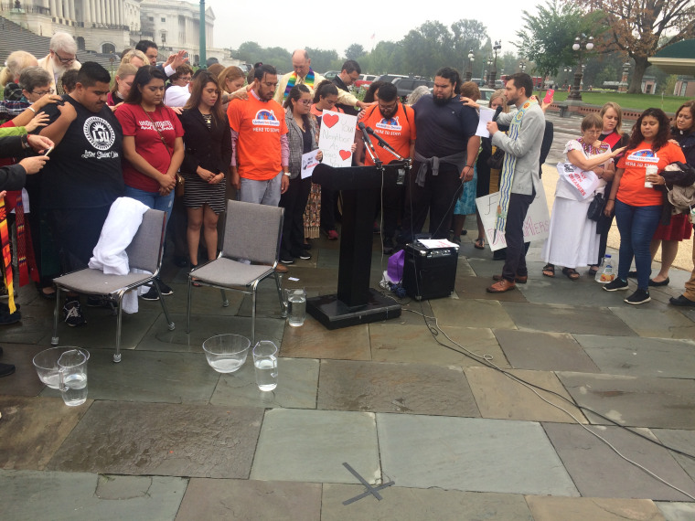 A group of clergy, immigrants and activists pray together in front of the Capitol on Sept. 13, 2017.