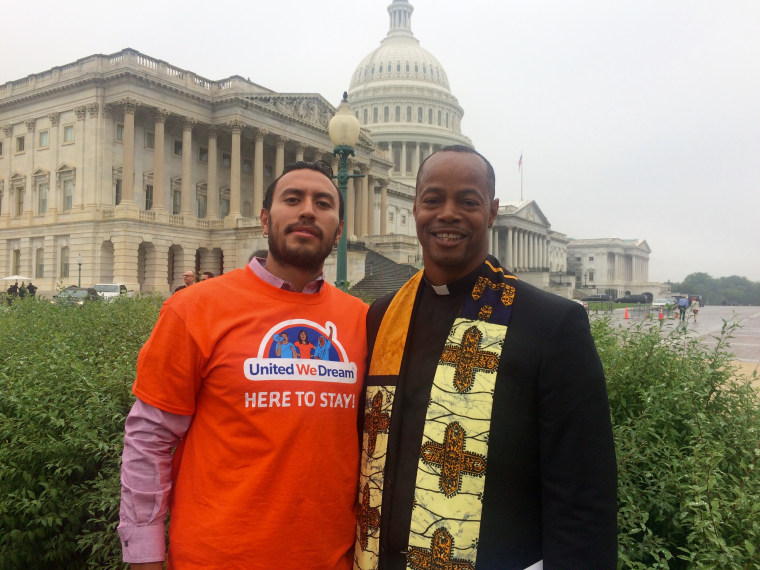 The Rev. Reuben Eckels of Church World Service washed the feet of Irvin Enriquez of Washington State to pressure Congress to address the predicament of DACA recipients. Thw two posed after at the Capitol on Sept. 13, 2017.