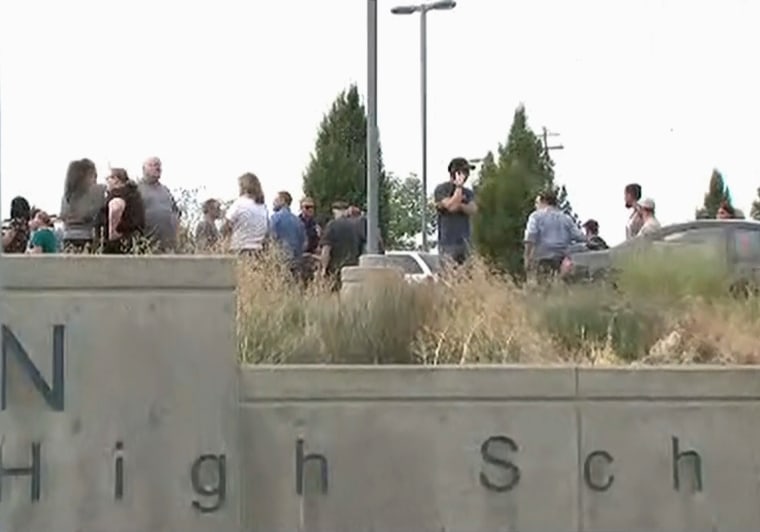 Image: People including parents stand outside Freeman High School in Spokane, Washington