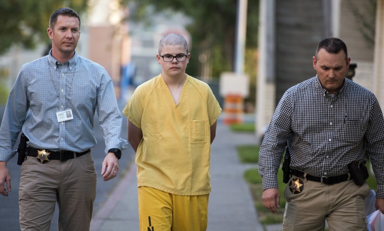 Image: Spokane County Sheriff's deputies escort Caleb Sharpe from the Public Safety Building to the Juvenile Detention Center in Spokane