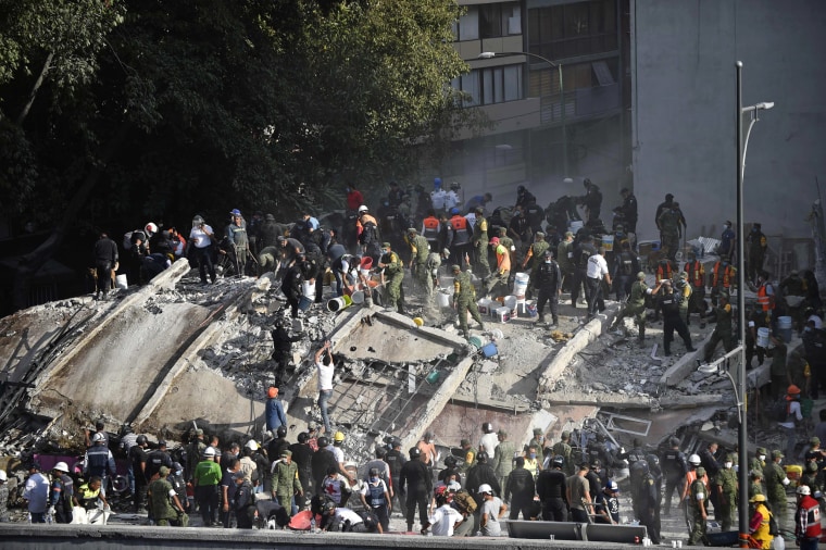 Image: Rescuers search for survivors after a building was flattened during the earthquake in Mexico City