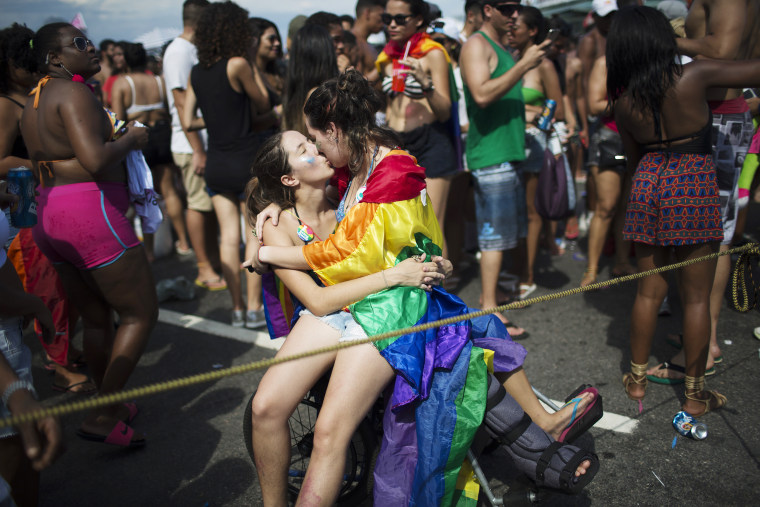 Image: Two women kiss during the Gay Pride Parade at Copacabana beach in Rio de Janeiro, Brazil