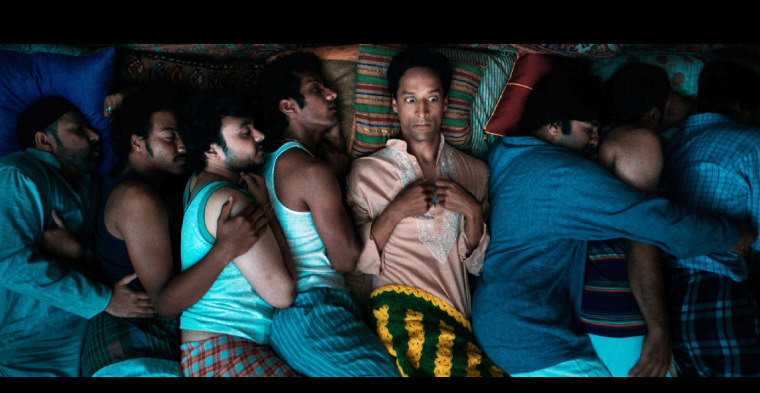 Danny Pudi (center) stars as Sami Malik, an immigrant living in a very cramped Chicago apartment, in "The Tiger Hunter."