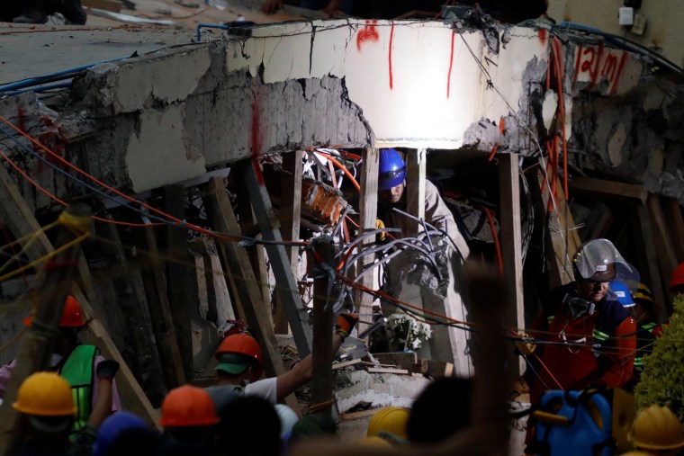 Image: Rescue workers search through the rubble for students at Enrique Rebsamen school after an earthquake in Mexico City