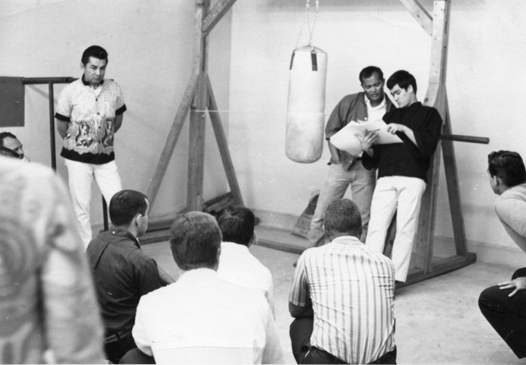 Dan Inosanto and Bruce Lee teach a martial arts lesson.