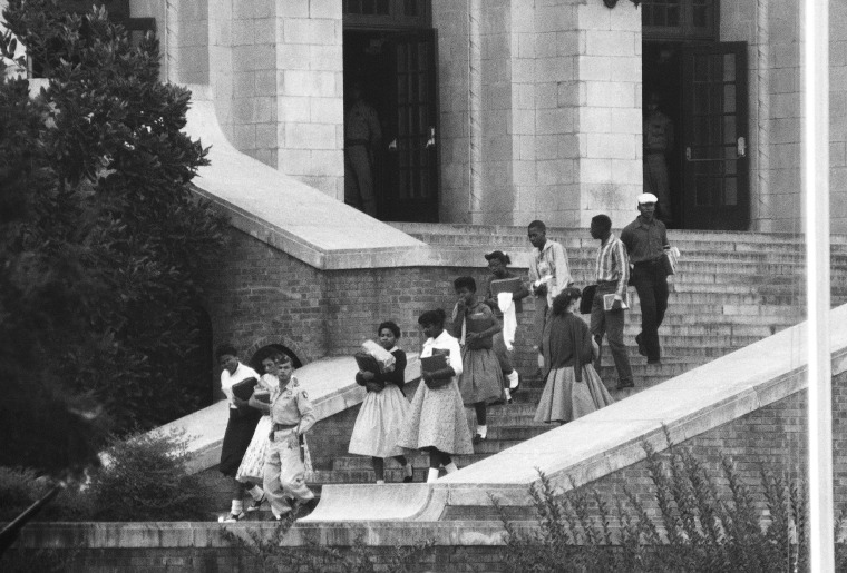 Image: Seven of the nine African American students walk onto the campus of integrated Central High School