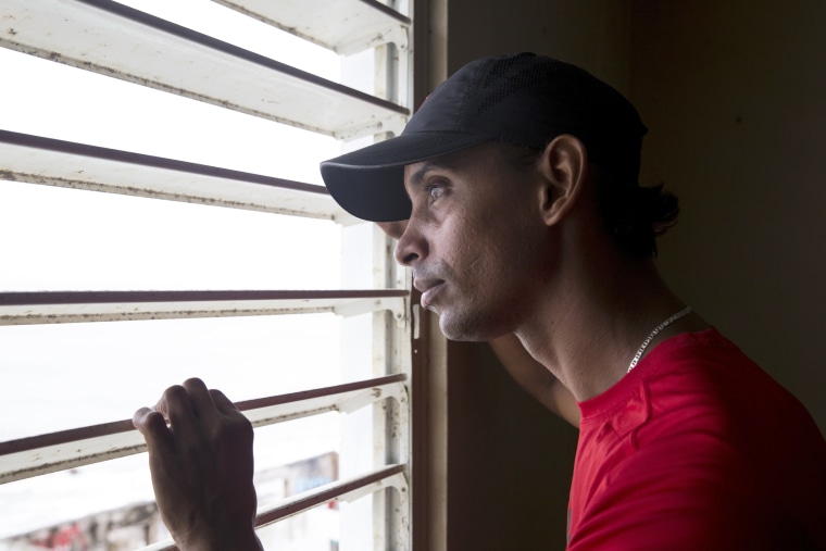 Image: Geraldo Ramirez, 36, in his home on Calle San Miguel in the La Perla neighborhood the day after Hurricane Maria made landfall on Sept. 21, 2017 in San Juan, Puerto Rico.