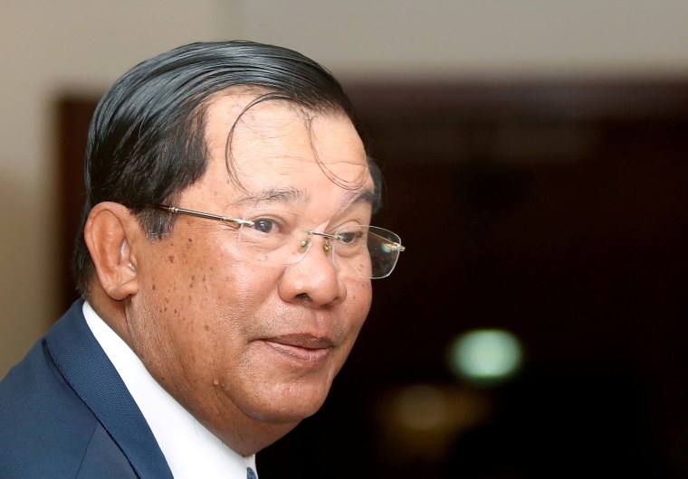 Image: FILE PHOTO - Cambodia's Prime Minister Hun Sen smiles as he arrive at the National Assembly of Cambodia during a plenary session, in central Phnom Penh