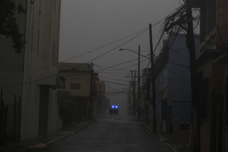 Image: A police car patrols a road as Hurricane Maria hits Puerto Rico in Fajardo