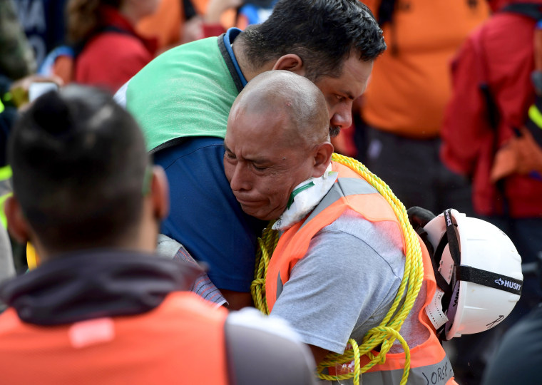 Image: Rescue workers embrace each other deeply moved after a seismic alert sounded in Mexico City on Sept. 23, 2017, four days after the powerful quake that hit central Mexico.