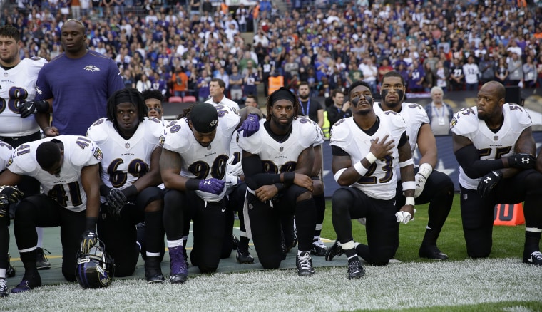 Baltimore Ravens players kneel during the playing of the U.S. national anthem before their game against the Jacksonville Jaguars at Wembley Stadium in London on Sunday.