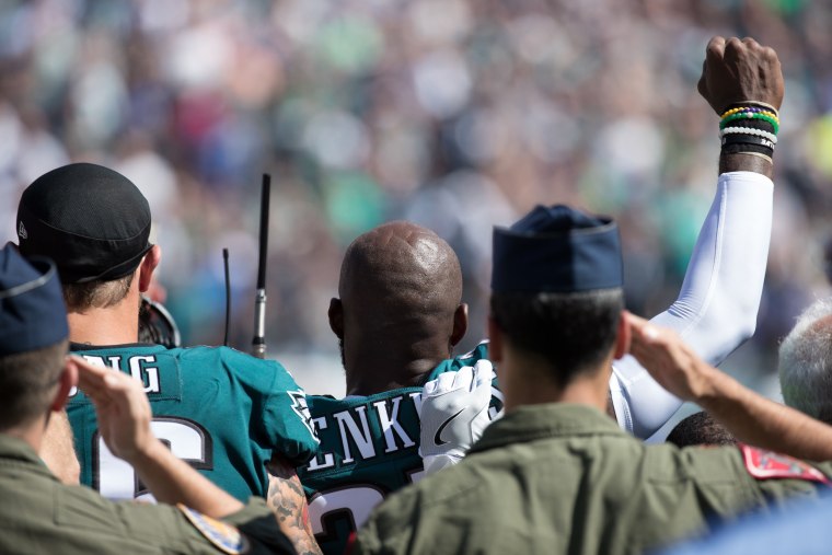 Image: Philadelphia Eagles strong safety Malcolm Jenkins (27) and defensive end Chris Long (56) stand for the anthem