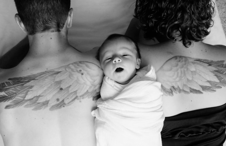 Claire Kimmel rests on the backs of her parents, close to their angel wing tattoos intended to memorialize her older brother, Isaac.