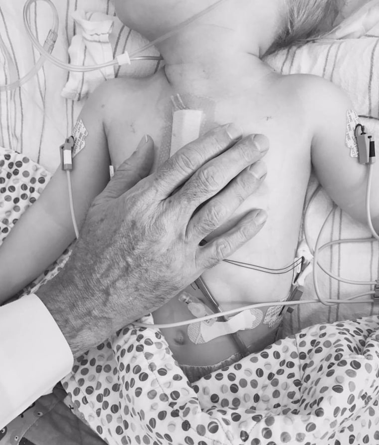 Dr. Thomas Spray's hand over Finn's heart, moments after surgery.