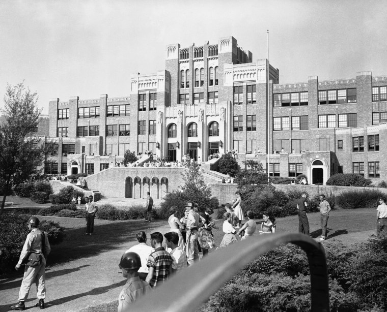 Students and members of the National Guard outside Central High School in Little Rock, Ark., weeks before nine black students entered the school protected by members of the 101st Airborne. The 60th anniversary of the Little Rock Nine's enrollment is Monday, Sept. 25, 2017. (AP Photo/William P. Straeter, File)