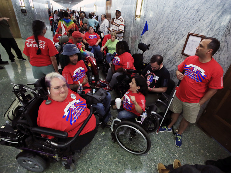 Image: Marilee Adamski-Smith from Brookfield, Wisconsin, left, and Colleen Flanagan of Boston, center, join others outside a hearing room where the Senate Finance Committee will hold a hearing to consider the Graham-Cassidy healthcare proposal