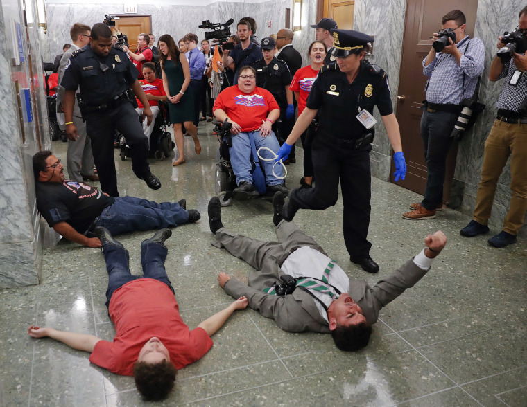 Image: U.S. Capitol Police detain protesters laying on the ground