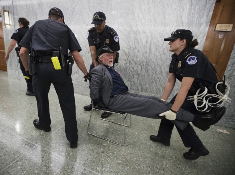 Image: Activists opposed to the GOP's Graham-Cassidy health care repeal bill, many with disabilities, are removed by U.S. Capitol Police
