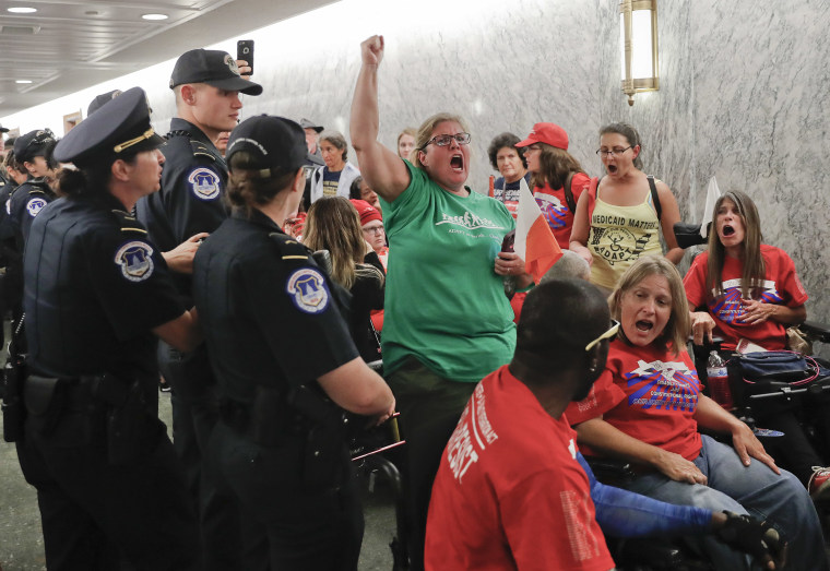 Image: A woman begins to yell as U.S. Capitol Police are about to detain her