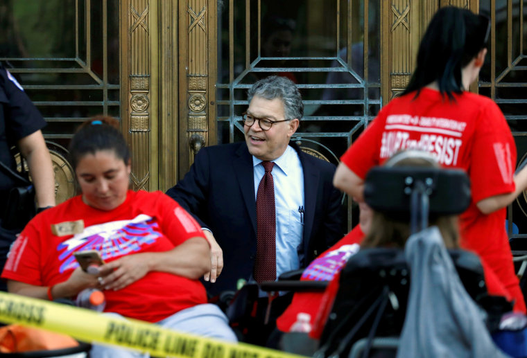 Image: Sen. Al Franken tries to enter Dirksen Senate Office Building as Capitol Police detain demonstrators as the Senate Finance Committee holds a hearing on the latest Republican Effort to repeal and replace the Affordable Care Act on Capitol Hill in Wa