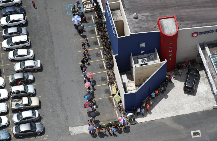 Image: People wait in a long line at a bank aftermath of Hurricane Maria