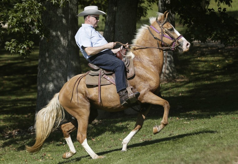 Image:  Moore rides in on a horse to vote at the Gallant Volunteer Fire Department during the Alabama Senate race