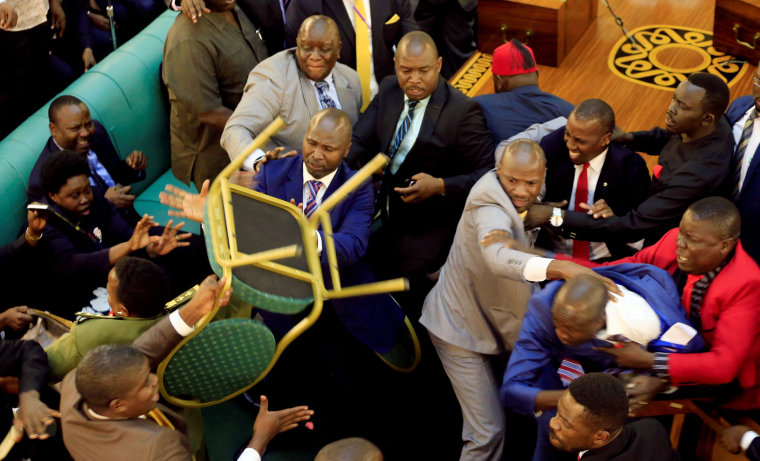 Image: Ugandan lawmakers involve in a fight in the parliament ahead of proposed age limit amendment bill debate a move to change the constitution to extend the president's rule, in Kampala