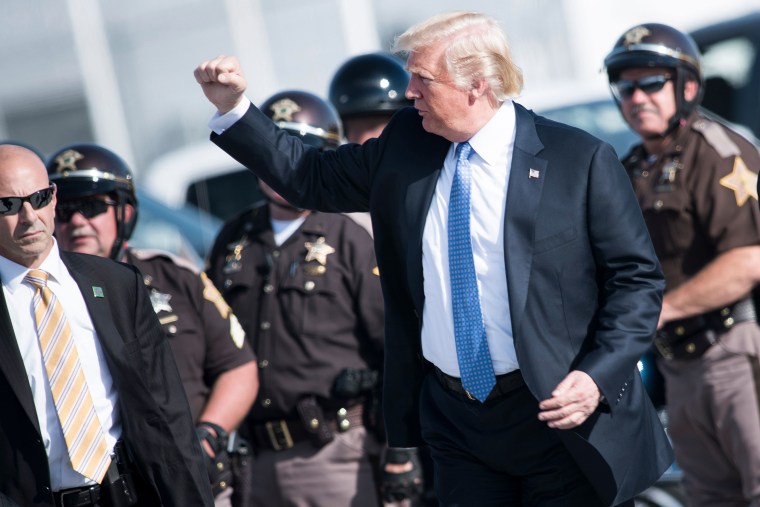 Image: US President Donald Trump walks from motorcycle police to Air Force One at Indianapolis International Airport