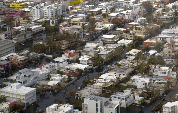 Image: Buildings are surrounded by flood water in San Juan