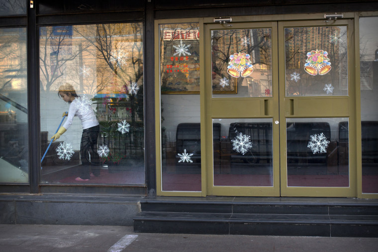 A worker sweeps the floor inside a branch of the North Korean-operated Haedanghwa restaurant in Beijing on Feb. 17, 2016.