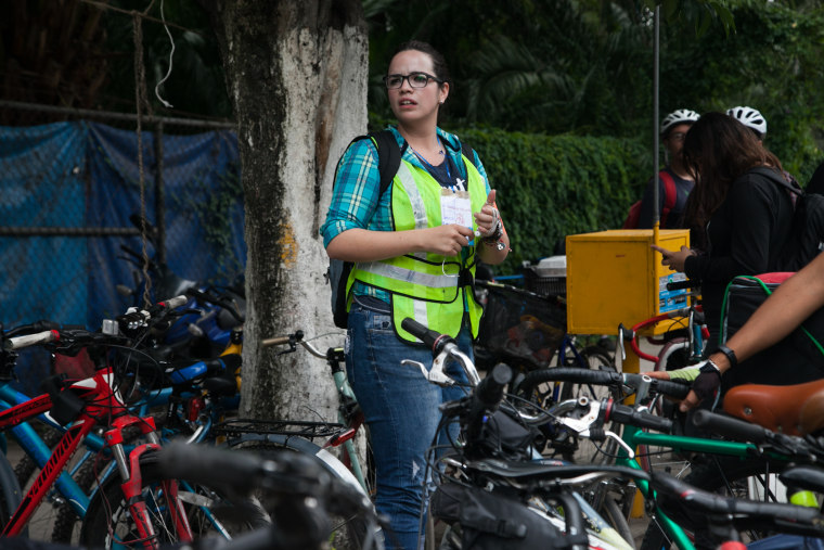 A volunteer at the Roma neighborhood in Mexico City gives instructions to a cyclist brigade as they prepare to deliver supplies following the earthquake.