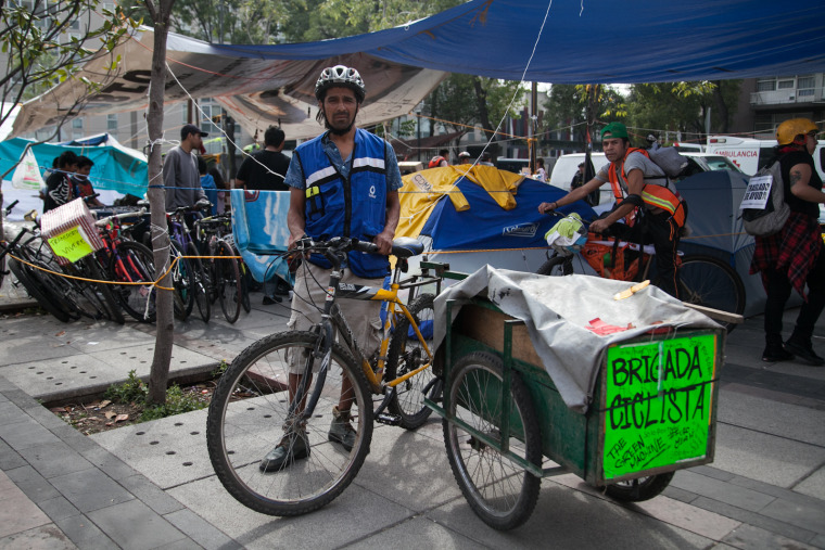 Rafael Mendoza delivers essential supplies with his bike cart twelve hours a day.