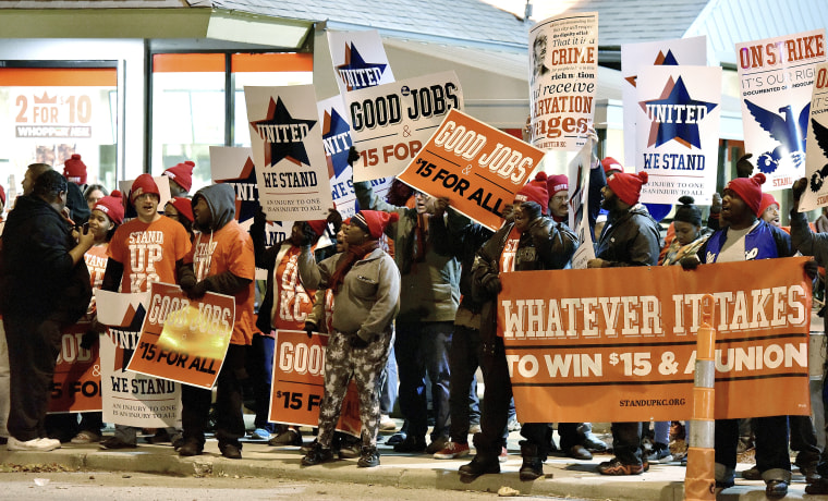 Image: Protesters gather in front of a Burger King in the 3400 block of Main Street