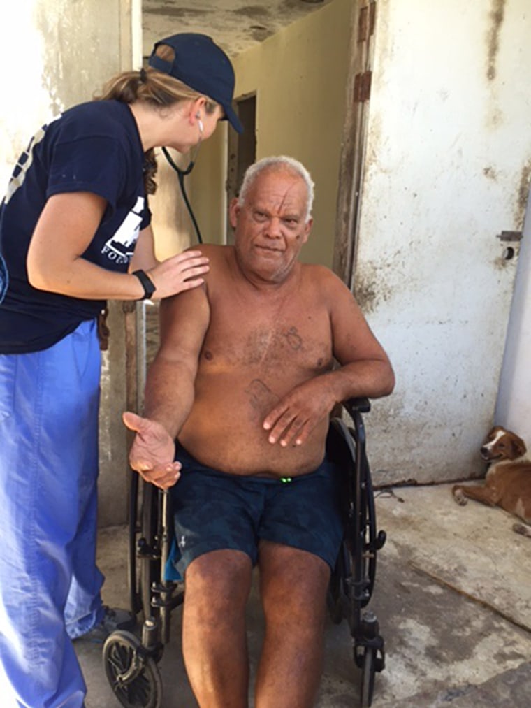 Image: Nicole Merrill, a Nurse practitioner From Portland Maine, checks on Isabelino Aponte Rivera, 70, resident of Loiza, Puerto Rico.